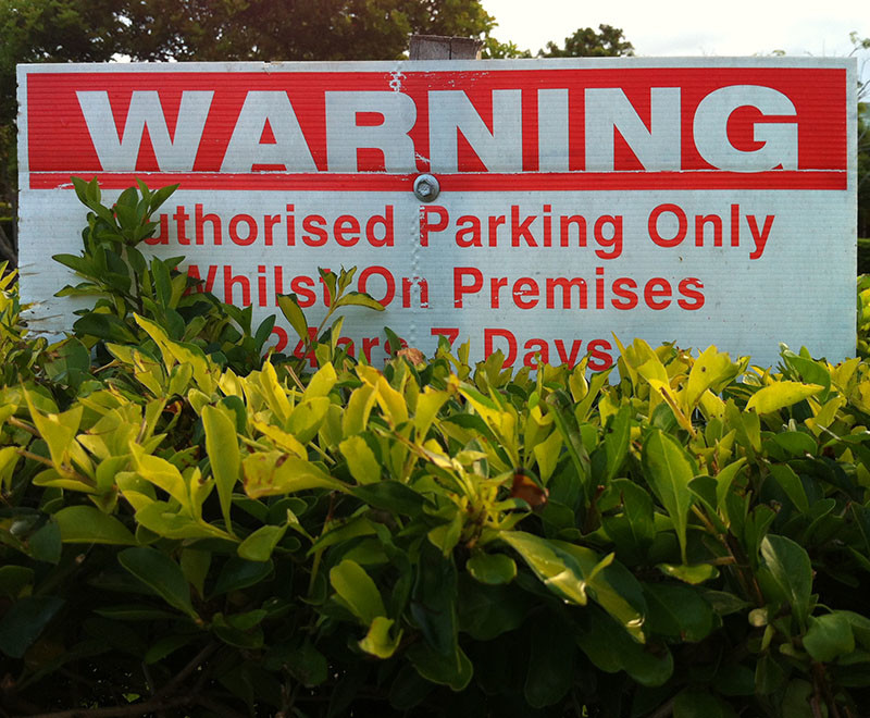 signage obscured by vegetation